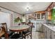 Bright kitchen featuring granite countertops, classic cabinetry, and casual dining area at 729 S Carolina Ave, Henderson, NC 27536