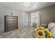Cozy living room featuring wood-look floors, paneled walls, and natural light from the window at 729 S Carolina Ave, Henderson, NC 27536