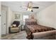 Relaxing bedroom features a decorative bed, comfortable chair, and ceiling fan for added comfort at 729 S Carolina Ave, Henderson, NC 27536