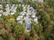 Overhead shot of a neighborhood street showcases beautiful homes among mature trees and peaceful atmosphere at 733 Holding Ridge Ct, Wake Forest, NC 27587