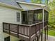 Back deck with screened-in porch, ceiling fan, and wood railings at 733 Holding Ridge Ct, Wake Forest, NC 27587