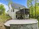 A spacious backyard with a stone patio, perfect for outdoor gatherings, and a hot tub under a covered patio at 733 Holding Ridge Ct, Wake Forest, NC 27587