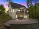 Expansive backyard featuring a screened porch, deck, and paver patio with a hot tub, perfect for outdoor living at 733 Holding Ridge Ct, Wake Forest, NC 27587
