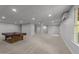 Basement area with a pool table, great lighting, and neutral-colored walls and flooring at 733 Holding Ridge Ct, Wake Forest, NC 27587