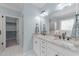 Bathroom featuring double vanity with granite countertops and a walk-in closet at 733 Holding Ridge Ct, Wake Forest, NC 27587