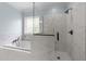 Modern bathroom with a large soaking tub and separate glass-enclosed shower at 733 Holding Ridge Ct, Wake Forest, NC 27587