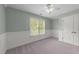 Bedroom with wainscoting, plush carpet flooring, and large window at 733 Holding Ridge Ct, Wake Forest, NC 27587