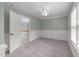 Bedroom with wainscoting, carpet flooring, large window, and closet at 733 Holding Ridge Ct, Wake Forest, NC 27587