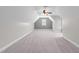 A large bonus room features neutral walls, vaulted ceilings, and a window at 733 Holding Ridge Ct, Wake Forest, NC 27587
