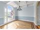 Elegant dining room with hardwood floors, a coffered ceiling, and a large window offering plenty of natural light at 733 Holding Ridge Ct, Wake Forest, NC 27587