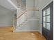 Bright foyer featuring hardwood floors, a grand staircase, and an open layout with ample natural light at 733 Holding Ridge Ct, Wake Forest, NC 27587