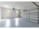 Clean, spacious two-car garage with an epoxy floor, garage door opener, and natural light at 733 Holding Ridge Ct, Wake Forest, NC 27587
