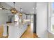 Open-concept kitchen featuring a granite island, stainless appliances, and pendant lighting at 733 Holding Ridge Ct, Wake Forest, NC 27587