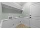 A laundry room with wainscoting, washer/dryer hookups, utility sink, and tiled flooring at 733 Holding Ridge Ct, Wake Forest, NC 27587