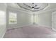 Spacious main bedroom with trey ceiling, carpet, and large windows at 733 Holding Ridge Ct, Wake Forest, NC 27587