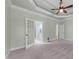 Main bedroom with trey ceiling, carpet, with entrances to bathroom and hallway at 733 Holding Ridge Ct, Wake Forest, NC 27587