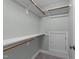 Bright walk-in closet featuring shelving, wood rods, carpet, and access door for extra storage at 733 Holding Ridge Ct, Wake Forest, NC 27587