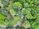 Aerial view of a house surrounded by lush trees and a green lawn at 831 Healey Ln, Durham, NC 27705