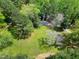 An aerial view of a home surrounded by trees and greenery, showcasing its secluded location at 831 Healey Ln, Durham, NC 27705