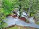 Stunning aerial view of the home with a spacious driveway and lush greenery surrounding the property at 831 Healey Ln, Durham, NC 27705