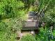 Overhead view of the house with a dark brown roof surrounded by lush trees and greenery at 831 Healey Ln, Durham, NC 27705
