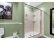 Modern bathroom featuring a marble shower, toilet, and decorative cow art at 831 Healey Ln, Durham, NC 27705