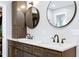 Bathroom features a modern double sink with a white countertop and two round mirrors at 831 Healey Ln, Durham, NC 27705