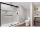 Contemporary bathroom with a glass enclosed shower, gray walls, and modern toilet at 831 Healey Ln, Durham, NC 27705