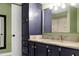 Stylish bathroom featuring a granite countertop and navy blue cabinets with gold hardware at 831 Healey Ln, Durham, NC 27705