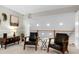 Bright bonus room with wood railing overlooking the floor below featuring two chairs and a unique side table at 831 Healey Ln, Durham, NC 27705