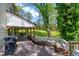 Outdoor deck with wooden pillars and seating, ideal for gatherings and enjoying the scenic wooded view at 831 Healey Ln, Durham, NC 27705
