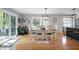 Charming dining area featuring modern lighting, large windows with wooded views, and access to the deck at 831 Healey Ln, Durham, NC 27705