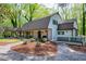 Charming home exterior with covered porch, stone pathway, fresh mulch and a cozy, inviting ambiance at 831 Healey Ln, Durham, NC 27705