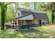 Well-kept home featuring a covered deck, lush greenery, and a peaceful, tree-lined setting at 831 Healey Ln, Durham, NC 27705