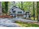 Inviting two-story home with white siding, a charming porch, and lush surrounding greenery at 831 Healey Ln, Durham, NC 27705