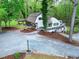 Charming exterior view of the house with a covered porch, side deck, and beautiful yard with trees at 831 Healey Ln, Durham, NC 27705