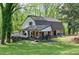 Charming two-story home with a covered deck, well-manicured lawn, and inviting curb appeal at 831 Healey Ln, Durham, NC 27705