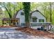 Charming home with a covered porch and a large tree in the front yard at 831 Healey Ln, Durham, NC 27705