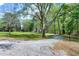 Picturesque view of a lush front yard leading to a charming home and wooded area at 831 Healey Ln, Durham, NC 27705