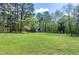 Picturesque setting of green lawn leading to house with large front yard and tree line at 831 Healey Ln, Durham, NC 27705