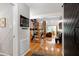Hallway featuring hardwood floors and open stairway, leading to the living room at 831 Healey Ln, Durham, NC 27705