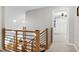 Upstairs hallway showing stairs and glimpses of the living room and bedroom areas at 831 Healey Ln, Durham, NC 27705