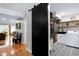 Laundry room featuring a black sliding barn door, washer, dryer, and storage at 831 Healey Ln, Durham, NC 27705
