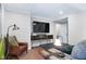 Comfortable living room with a large TV, leather chair, and coffee table at 831 Healey Ln, Durham, NC 27705