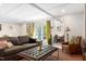 Inviting living room with modern coffered ceiling, couch, and outdoor views at 831 Healey Ln, Durham, NC 27705