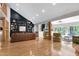Expansive living room featuring hardwood floors, stylish built-ins, and oversized windows with wooded views at 831 Healey Ln, Durham, NC 27705