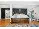 Beautiful main bedroom offers stylish accent wall and access to ensuite bathroom at 831 Healey Ln, Durham, NC 27705