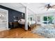 Spacious main bedroom with hardwood floors, access to a private deck, and an attached bathroom at 831 Healey Ln, Durham, NC 27705