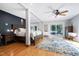 Comfortable main bedroom features wood floors, a ceiling fan, and a sliding glass door at 831 Healey Ln, Durham, NC 27705