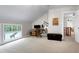 Bright home office with a desk, chair, and large window featuring views of the trees outside at 831 Healey Ln, Durham, NC 27705